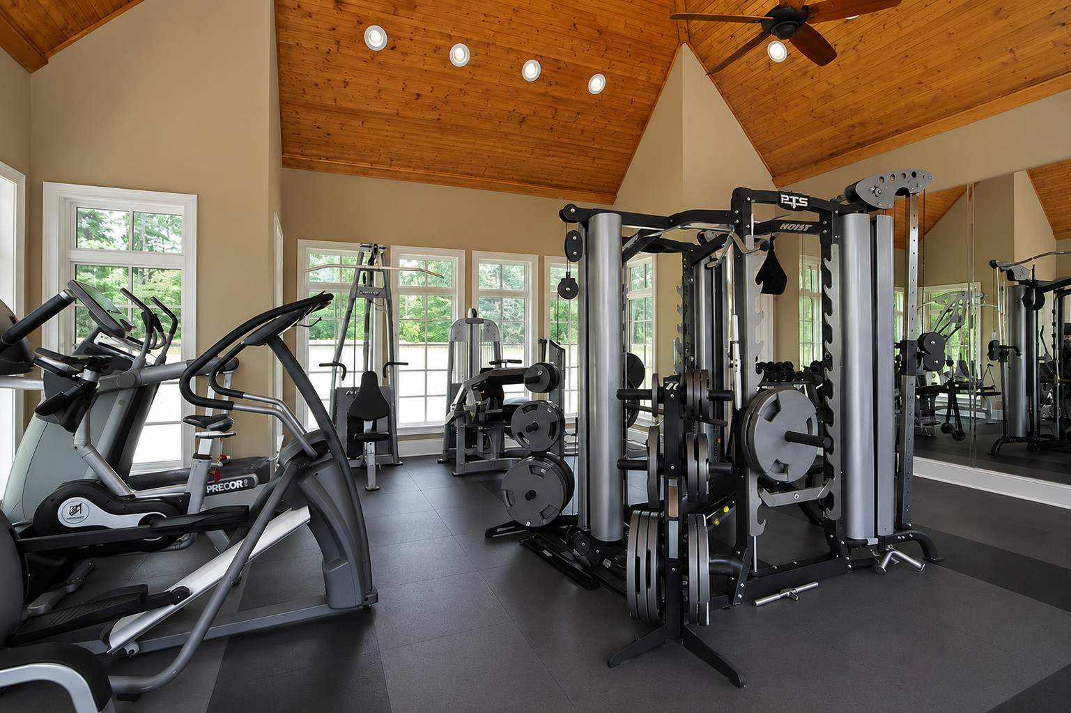Home gym with assembled cardio machines and a power rack