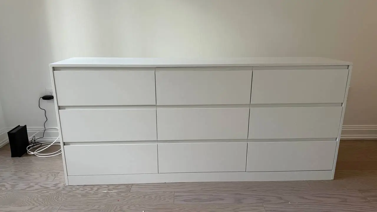 Nine-drawer white dresser assembled and leveled in an Austin bedroom
