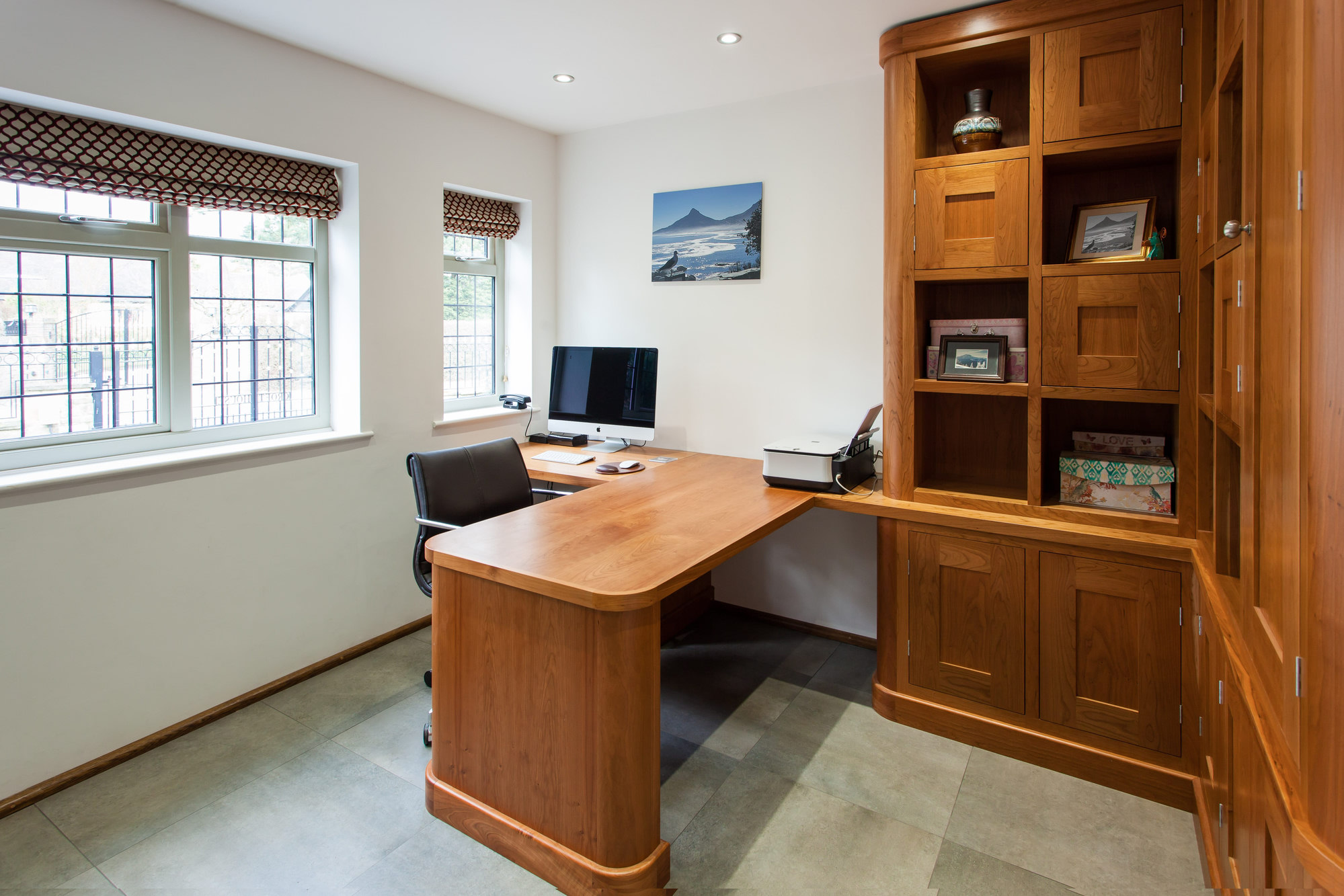 Assembled wooden L-shaped desk and storage in a home office