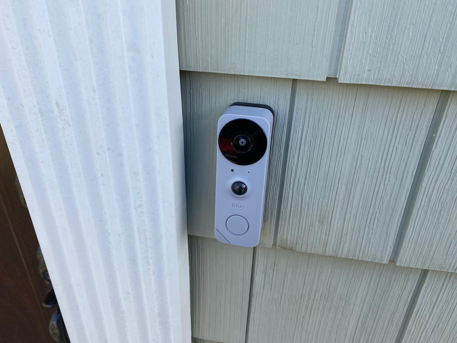 Smart video doorbell mounted on exterior siding