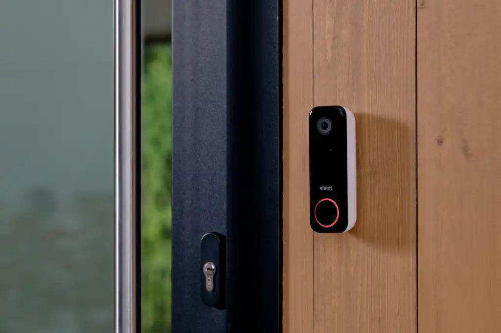 Smart video doorbell installed beside a front door
