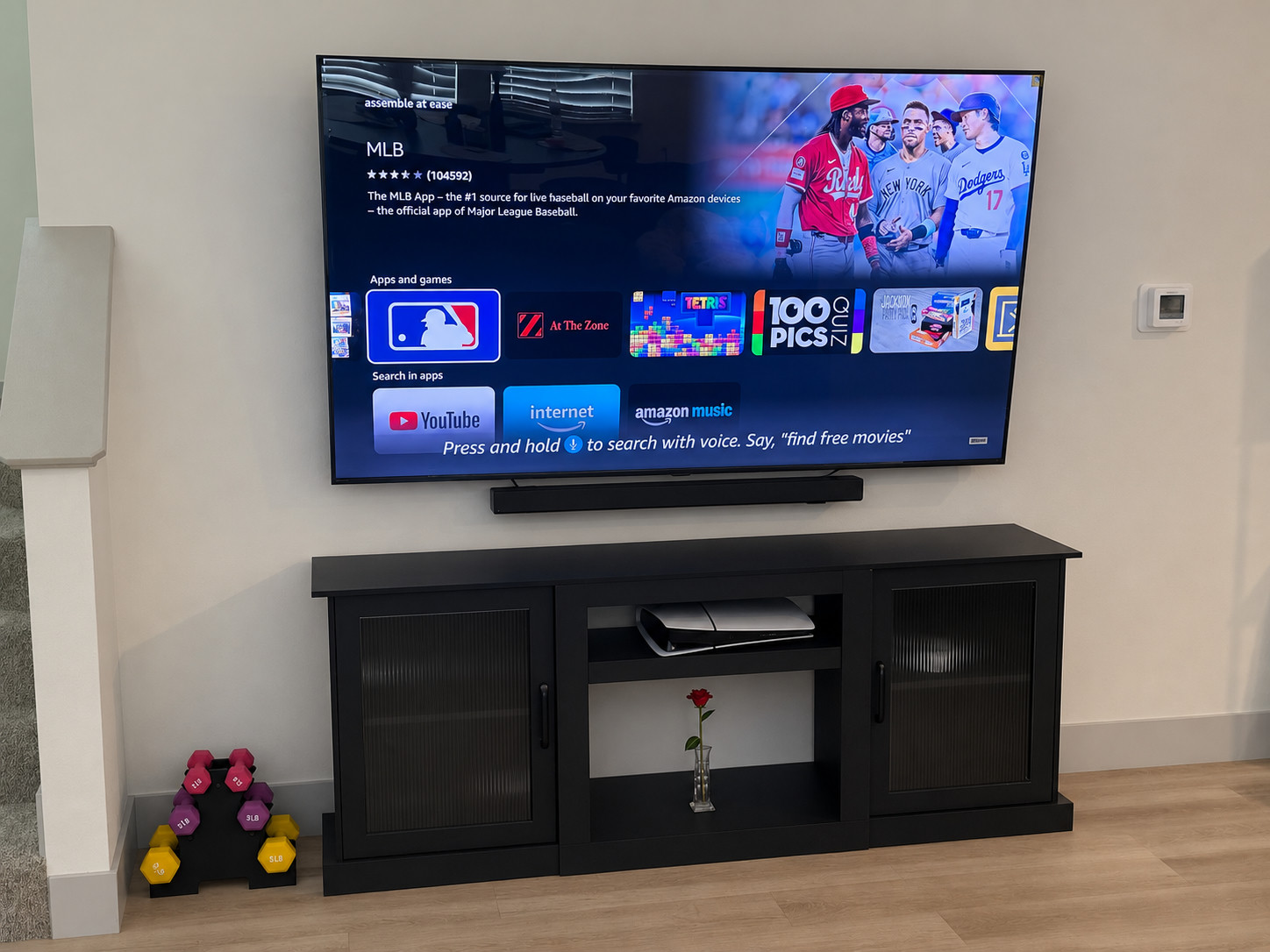 Large flat-screen TV wall-mounted above a media console